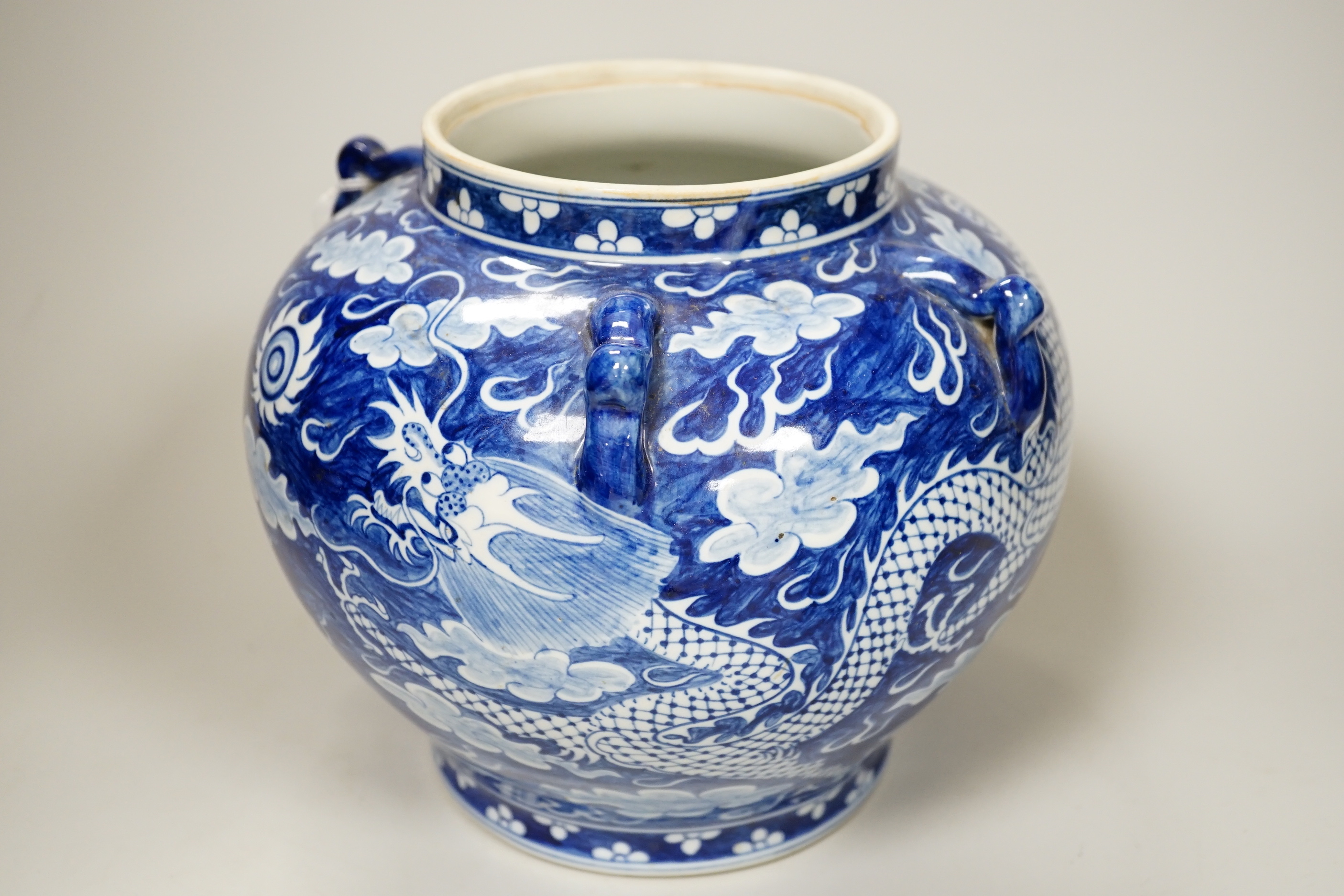 A group of Chinese ceramics including a celadon glazed vase, blue and white jar, white glazed figure and a jardiniere